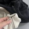 IMG_20261030_14804 Ruibang Apparel oatmeal and black cropped fleece hoodie zipper detail comparison